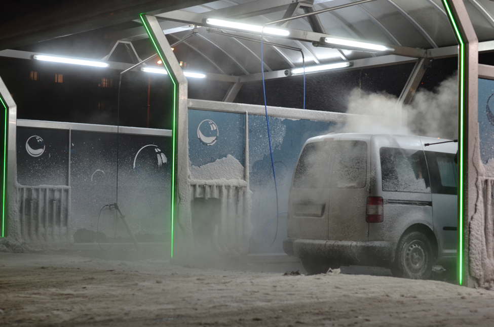 Car Being Cleaned in the Winter with Snow on Ground